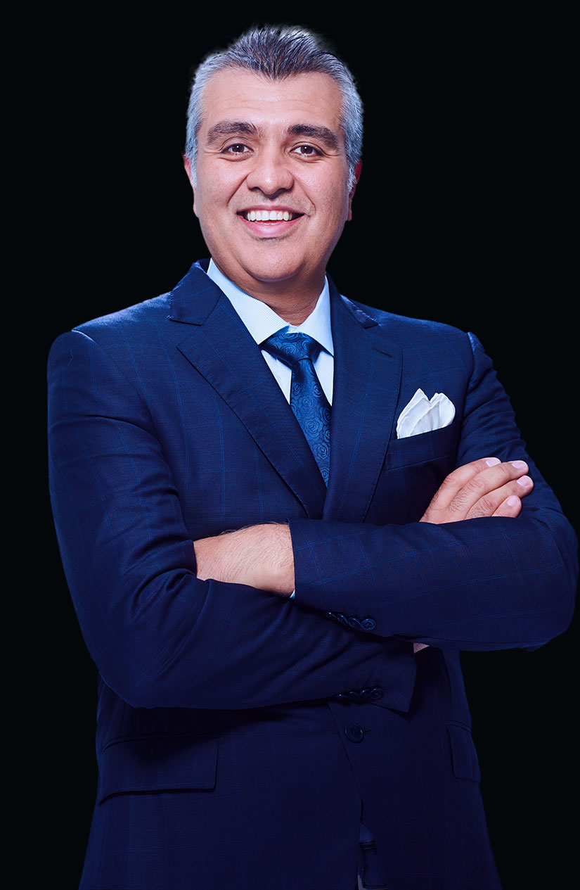 Dr. Ajang Yazdani in a suit with his arms folded